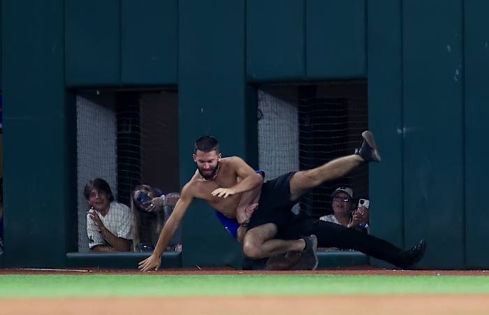 Jun 16, 2023; Arlington, Texas, USA; A fan is tackled by security during the game between the Texas Rangers and Toronto Blue Jays at Globe Life Field. Mandatory Credit: Kevin Jairaj-USA TODAY Sports